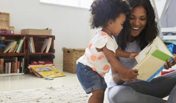 Lady and child reading a book.